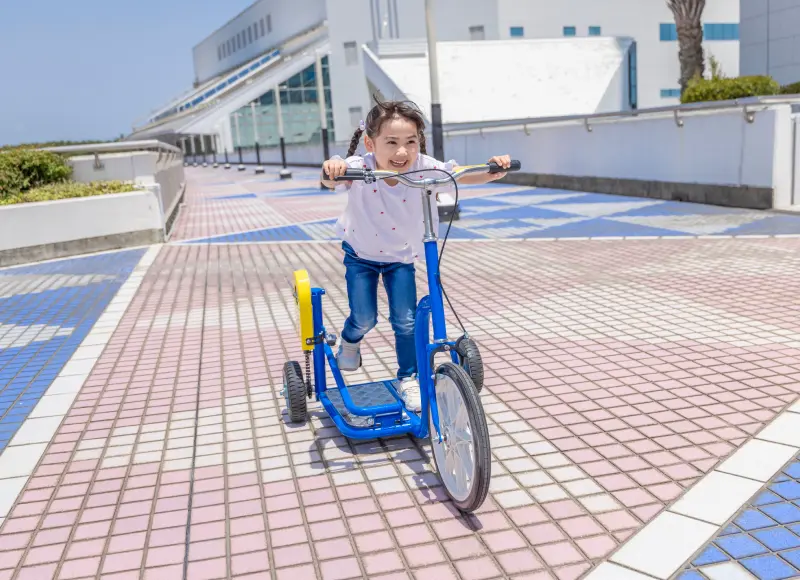 屋外でユニーク自転車を楽しむ女の子